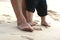 Grandma and the little one\'s feet in the sand