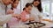 Grandma, mother and kids learning baking in a home kitchen counter together to prepare dessert as a skill or care