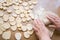 Grandma\'s hands roll out the dough