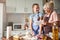 Grandma sharing her baking knowledge with jolly granddaughter