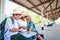 Grandma and two grandsons, look at the map to travel at the train station.