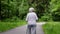Grandma walks in the park with sticks for Nordic walking in retirement