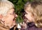 Grandmather and granddaughter in park