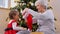 grandmother and baby girl opening christmas gift