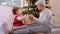 grandmother and baby girl opening christmas gift