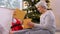 grandmother and baby girl opening christmas gift