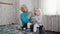 Grandmother brushing her granddaughters blonde hair with a hairbrush