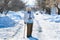 Grandmother with cane on road in park . old person leaning on a walking stick. caucasian female senior at cold winter