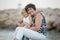 Grandmother and child, cute blond boy and young granny, hugging on the beach