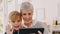 Grandmother, child and tablet in video call waving, blowing kiss or virtual greeting at home. Grandma sitting with