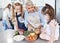 Grandmother, children and cooking in the kitchen together with vegetables in the family home. Cutting, food and elderly