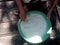 A grandmother cleaning rice in the village