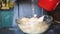 Grandmother cooking, preparing dough in flour, granny hands close up. Senior woman baking pastry in her home kitchen. Grandmother