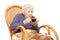 Grandmother drink coffee in an armchair