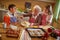 Grandmother enjoying with grandchildren preparing Christmas cook