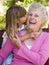 Grandmother getting a kiss from granddaughter