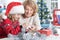 Grandmother with girl preparing for Christmas