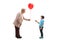 Grandmother giving a red balloon to a grandson