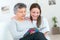 Grandmother and grandaughter reading at home