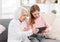 Grandmother with grandaughter using tablet