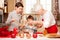 Grandmother with grandchilds in kitchen, christmas.