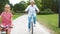 Grandmother and granddaughter cycling at park