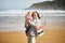 Grandmother and granddaughter enjoying Atlantic ocean on the beach