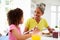 Grandmother And Granddaughter Having Breakfast Together