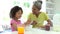 Grandmother And Granddaughter Having Breakfast Together