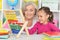 Grandmother and granddaughter learning to use abacus