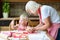 Grandmother and granddaughter making cookies together