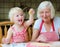 Grandmother and granddaughter making cookies together