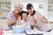 Grandmother, Granddaughter And Mother Baking Cake In Kitchen