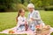 Grandmother and granddaughter at picnic in park