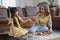 Grandmother and granddaughter play games. Blockwood Puzzle To develop skills for granddaughter and as a holiday activity