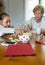 Grandmother and granddaughter playing domino