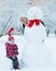 Grandmother with granddaughter playing in snow