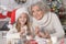 Grandmother and granddaughter preparing for Christmas