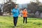 Grandmother and granddaughter running together. Old and young women in sports clothes, jogging in the park