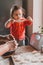 Grandmother and granddaughter sculpt dumplings with meat filling