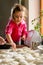 Grandmother and granddaughter sculpt dumplings with meat filling