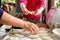 Grandmother and granddaughter sculpt dumplings with meat filling