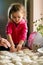 Grandmother and granddaughter sculpt dumplings with meat filling