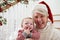 Grandmother With Granddaughter Sits On Stairs At Christmas