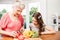 Grandmother and granddaughter slicing vegetables