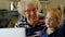 Grandmother and granddaughter using digital tablet in living room