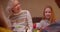 Grandmother with granddaughters Christmas dinner childhood joy gifts joy happiness smile sing song