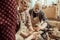 Grandmother and grandfather with granddaughter making pottery