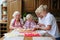 Grandmother with grandkids cooking in the kitchen