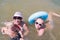 Grandmother, grandson and granddaughter swim in water in a swimsuite